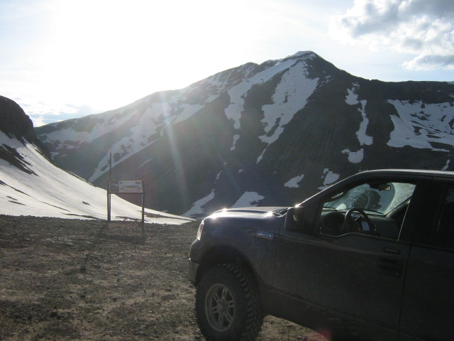 Dark pickup truck in a mountain landscape