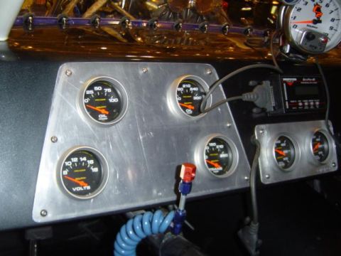 1979 Ford Bronco - A brushed-aluminum gauge panel mounted under the dash holds four black-faced Auto Meter gauges, oil pressure, oil temperature, voltmeter an…