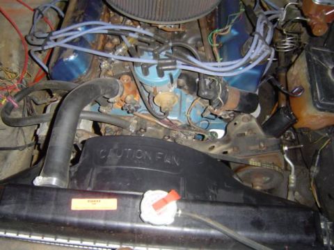1979 Ford Bronco - Close-up view of an engine bay, the radiator fan with 'CAUTION FAN' text and various engine components.