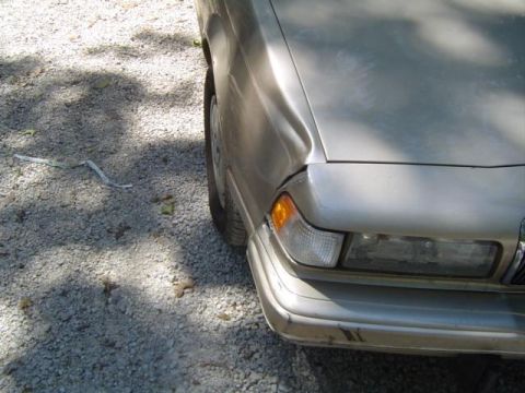 1979 Ford Bronco - Front corner of a silver car shows damage to the fender and bumper.
