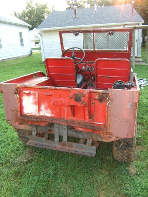 1946 Jeep CJ5 - This vintage Willys Jeep is seen from the rear, with its tailgate open, revealing the interior and dashboard.