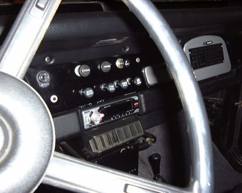 1974 Toyota Land Cruiser - The dashboard features a modern radio and several toggle switches, including one labeled 'CHOKE'.