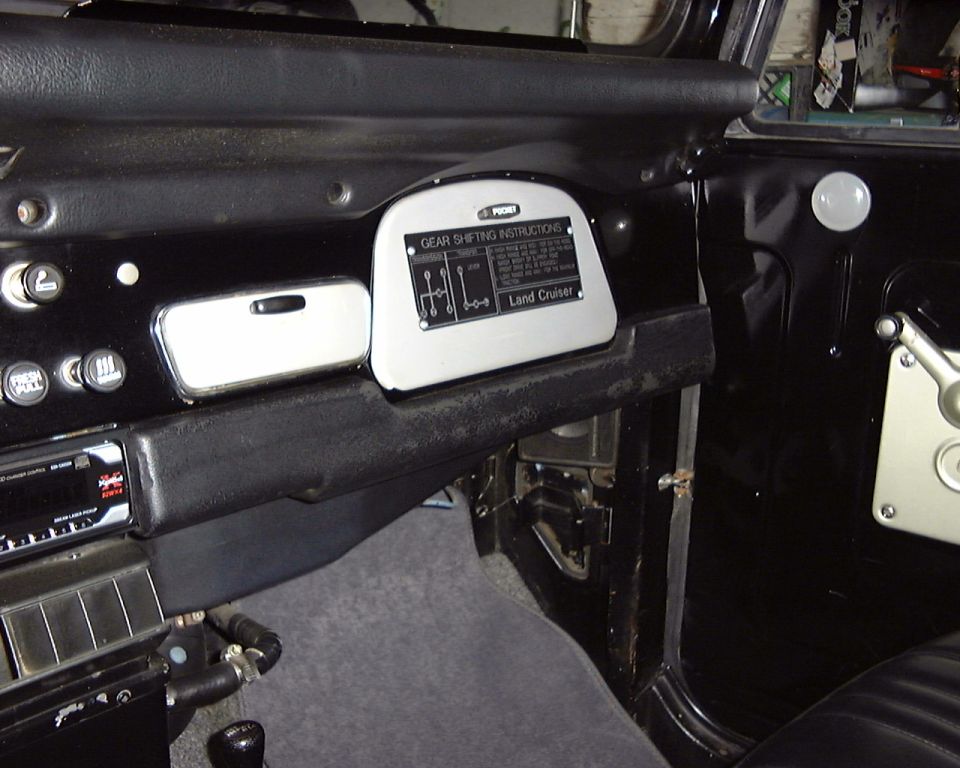 Land Cruiser interior with gear shifting instructions plate and aftermarket radio