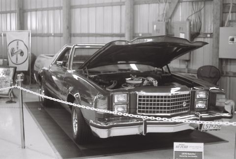 1973 Ford Ranchero - A 1973 Ford Ranchero is displayed with its hood open, revealing the engine bay.