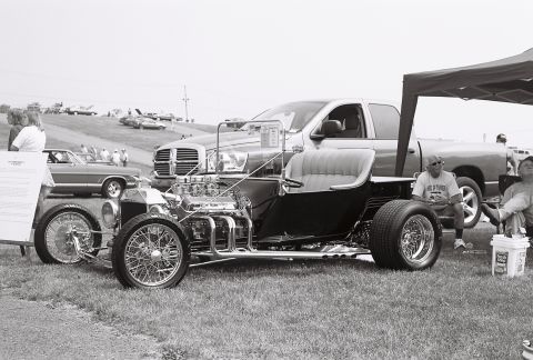 1973 Ford Ranchero - Custom hot rod on display with a modern pickup truck in the background at an outdoor event.
