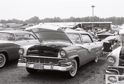 1973 Ford Ranchero - A classic 1956 Ford Fairlane Crown Victoria is displayed with its hood up at a car show.