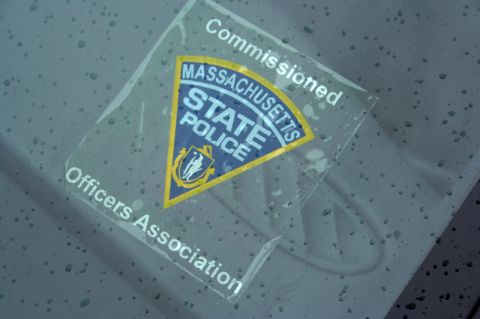 2000 Ford Crown Victoria - A sticker for the Massachusetts State Police Officers Association is affixed to the interior of a vehicle's window.