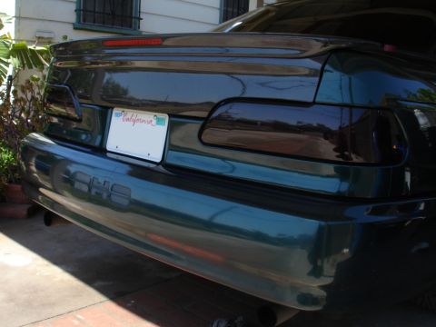 1993 Ford Taurus - Rear view of a 1993 Ford Taurus, tinted tail lights and a spoiler.