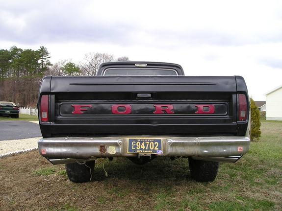 Rear view of black Ford pickup with red FORD tailgate letters and Delaware plate C94702