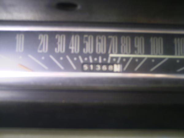 Blurry close-up of horizontal speedometer with odometer showing 51368 miles
