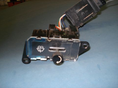 1979 Chevrolet C/K Pickup - A close-up view of a vehicle's wiper switch assembly, showing its controls and wiring harness connections.
