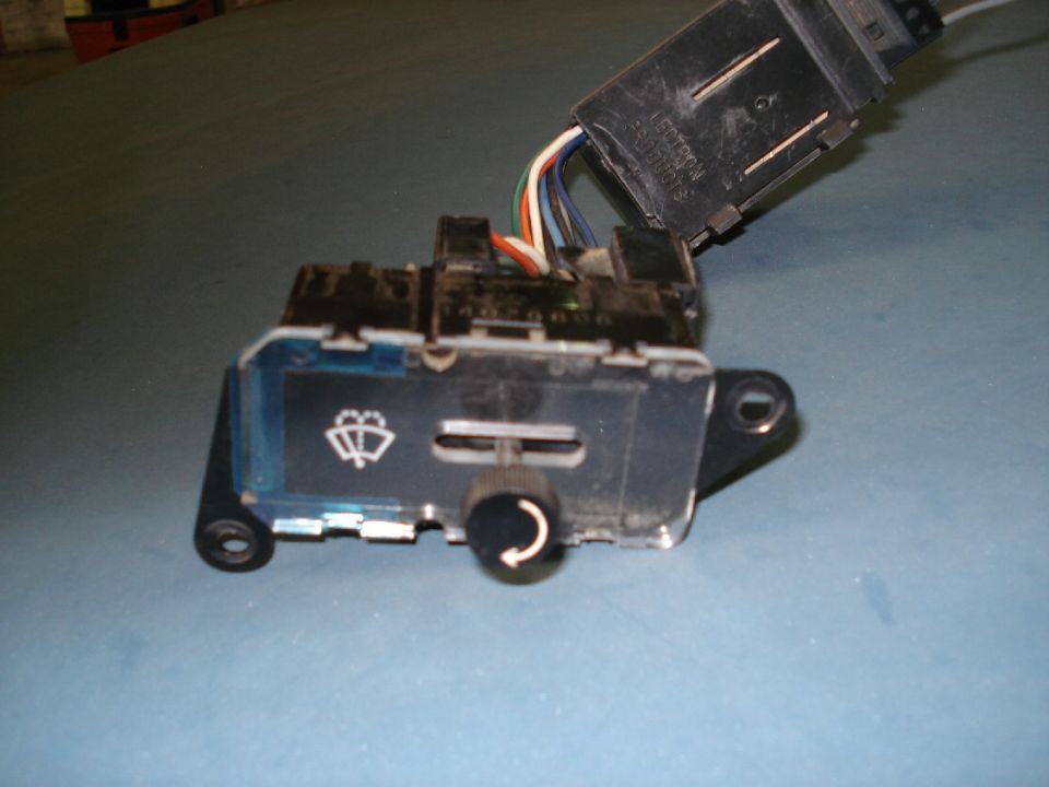 Wiper switch with a dial and a symbol for wipers. Wires connect to a black plastic housing