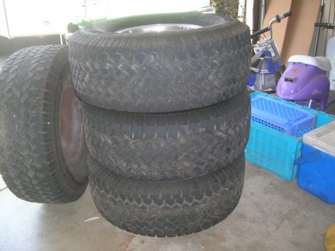 1985 Ford Bronco - A stack of four used tires is shown, with one tire on the left side partially visible.