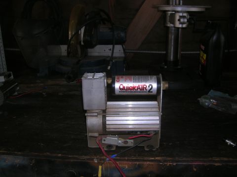 1985 Ford Bronco - A portable air compressor unit is shown with its label clearly visible.