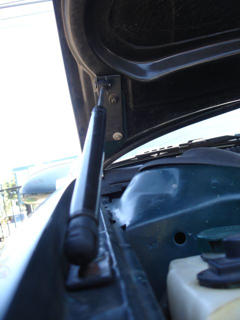 1993 Ford Taurus - Hood strut mount detail. The album claims 1993 Ford Taurus, but this is just a part.