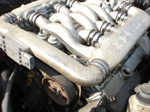 1991 Ford Taurus - Engine detail showing the SHO V6 intake manifold and timing belt. The text "SHO 3.4 VALVE DOHC" is visible.