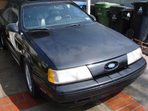 1991 Ford Taurus - Front view of a black 1991 Ford Taurus sedan.