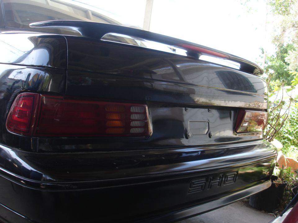 Rear of black Ford Taurus SHO showing tail light, spoiler and SHO badge