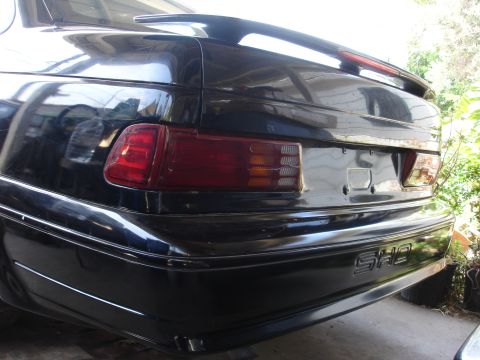 1991 Ford Taurus - Rear view of a black 1991 Ford Taurus SHO, showing the taillights and spoiler.
