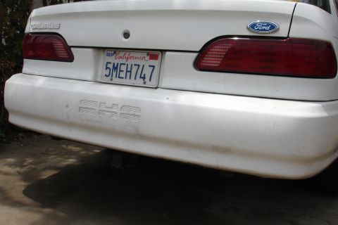 1992 Ford Taurus - Rear view of a white 1992 Ford Taurus SHO, the distinctive SHO badging on the bumper.