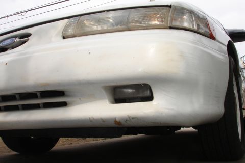 1992 Ford Taurus - Front view of a white 1992 Ford Taurus, showing the bumper and headlights.