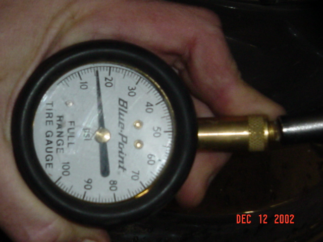 Close-up of a Blue-Point Full Range Tire Gauge dial reading about 5 PSI, held in hand