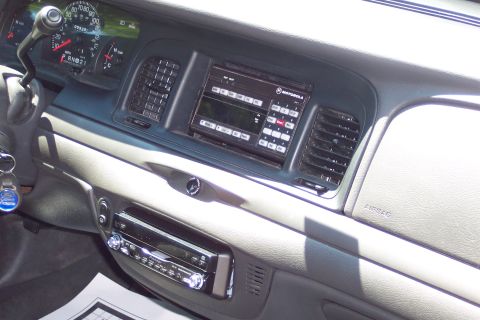 2001 Ford Crown Victoria - Interior view of a 2001 Ford Crown Victoria, a police radio and dashboard instruments.