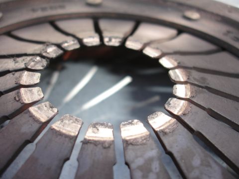 1992 Ford Taurus - This clutch disc shows significant wear and damage to its friction material, indicating it needs replacement.