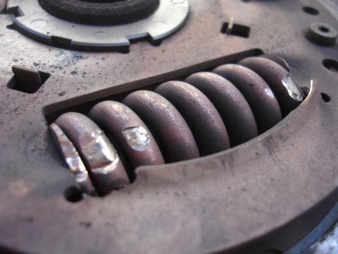 1992 Ford Taurus - A close-up view of the springs within a clutch pressure plate, revealing signs of wear and corrosion.