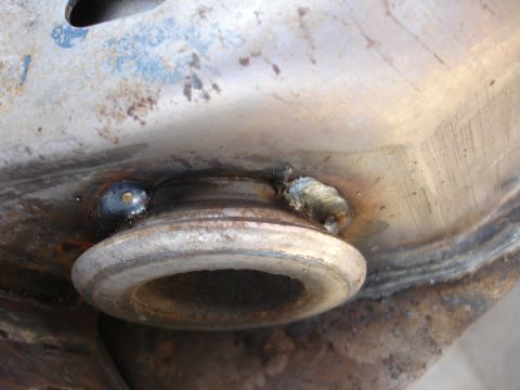 1992 Ford Taurus - A close-up view of a rusty, welded metal component, likely from a vehicle's suspension system.