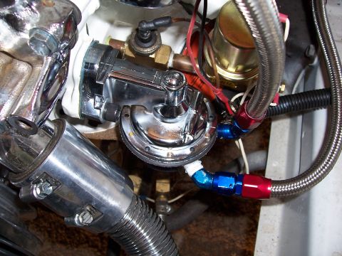 1978 Ford Mustang II - This image shows a chrome fuel pump with red and blue braided fuel lines, part of an engine bay.