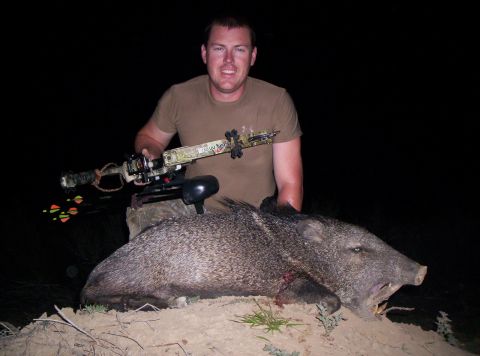 1986 Ford Bronco - Hunter poses with a javelina he hunted with a bow.