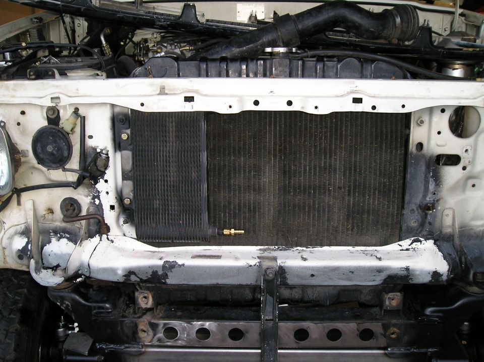Front radiator support and cooler of a vehicle with hood open