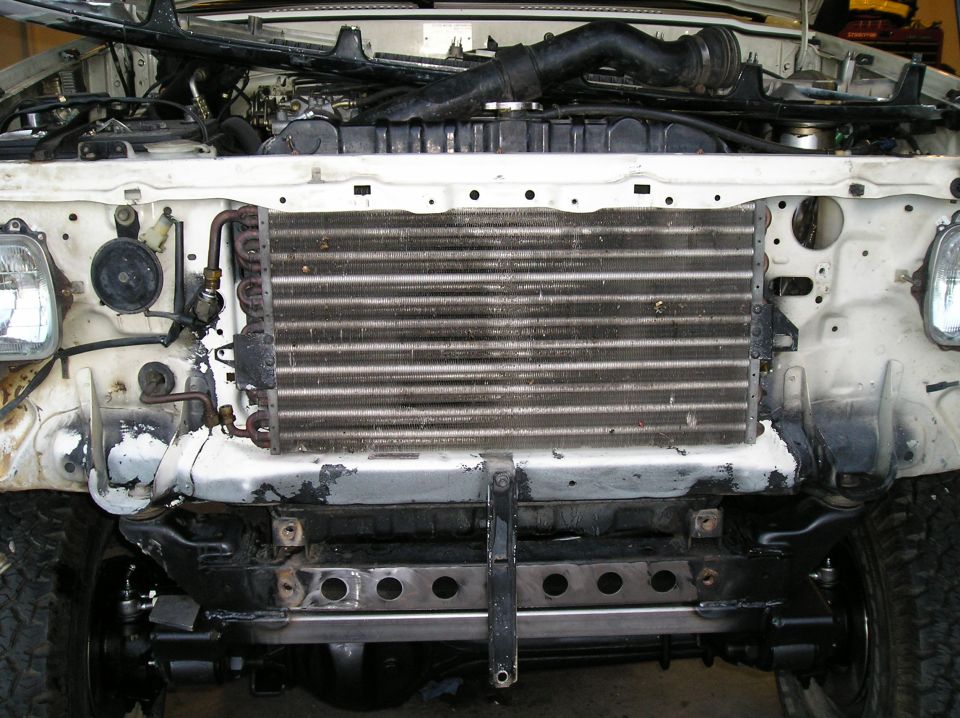 Front-mount intercooler installed behind the bumper of a vehicle