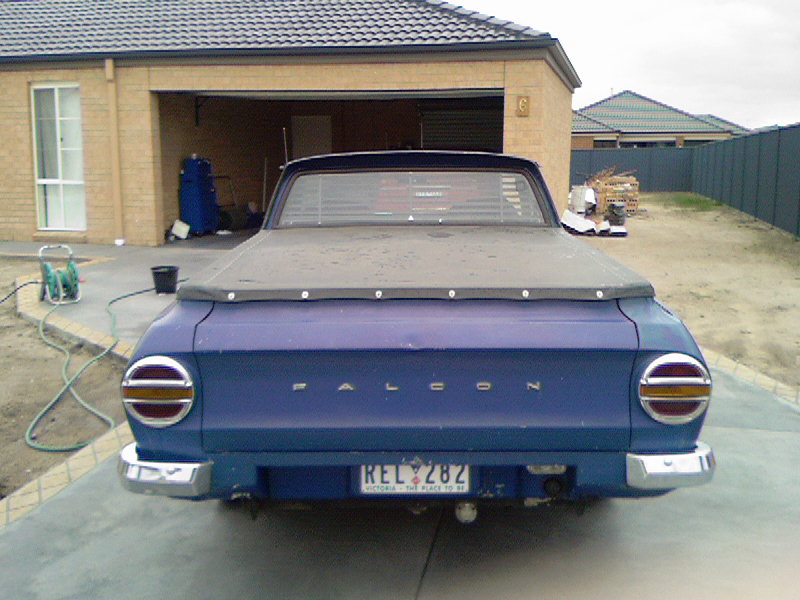 Rear of blue Ford Falcon ute with tonneau cover and Victoria plate REL 282 on driveway