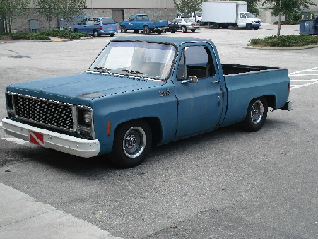 1979 Chevrolet C/K Pickup - This blue 1979 Chevrolet C/K Pickup truck is seen from a 3/4 front angle in a parking lot.