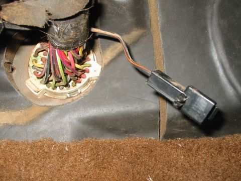 1988 Ford Bronco - Close-up of a vehicle's interior wiring harness connector with multiple colored wires.