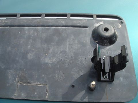 1996 Ford Bronco - Plastic trim piece shows embossed circular markings, including '92' and '93', with attached mounting hardware.