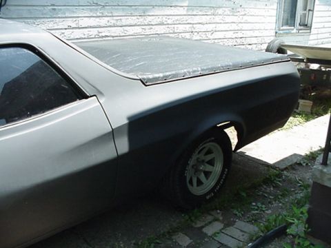 1972 Ford Ranchero - The side profile of a 1972 Ford Ranchero, partially painted and covered.