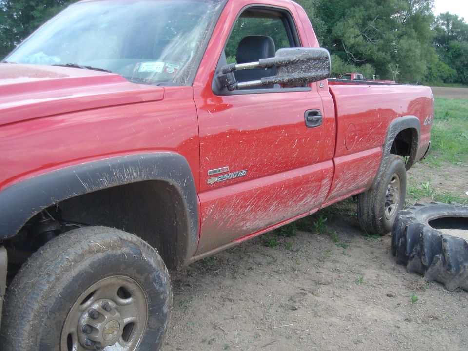 Red pickup truck with "2500 HD" badge, seen from the side