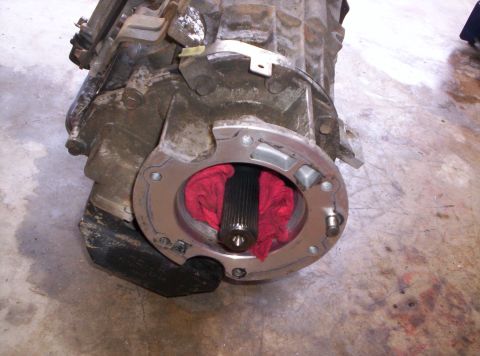 1995 Ford Bronco - Close-up of a transmission part with a splined output shaft visible.