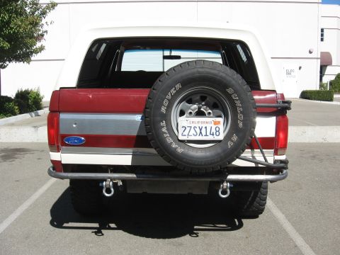 1991 Ford Bronco - Rear view of a 1991 Ford Bronco a custom bumper and a spare tire mounted on the tailgate.