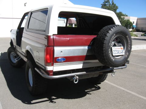 1991 Ford Bronco - Rear view of a 1991 Ford Bronco, showing the spare tire and custom bumper.