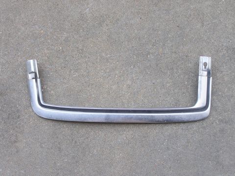 1973 Ford Ranchero - A chrome trim piece with a black insert is shown against a concrete background. This part is not definitively identified.