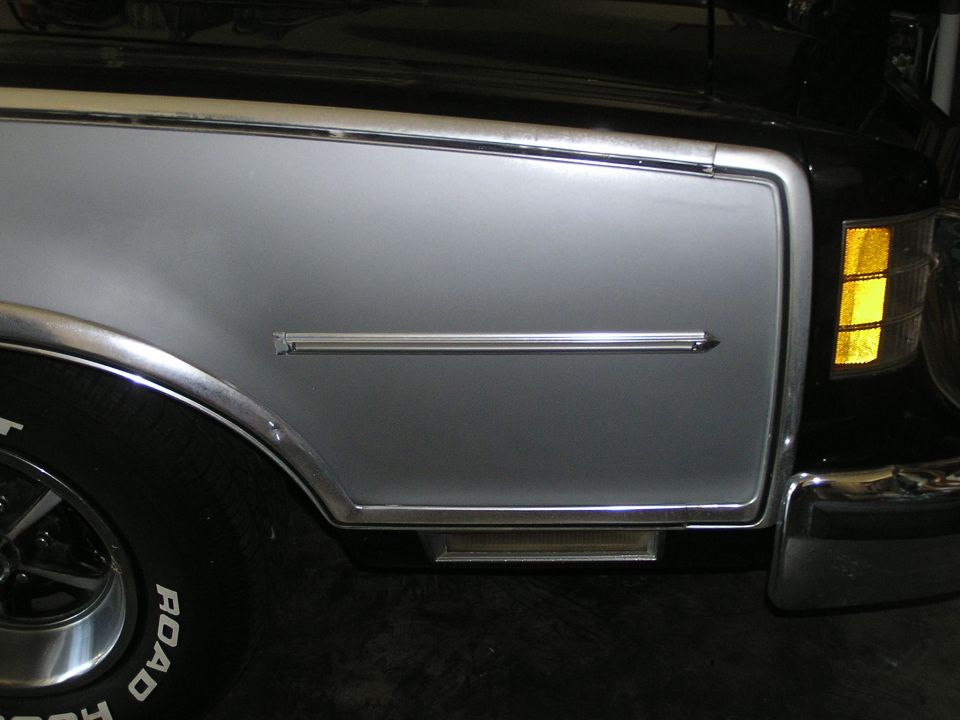 1973 Ford Ranchero front fender with silver two-tone paint, chrome trim, and amber turn signal