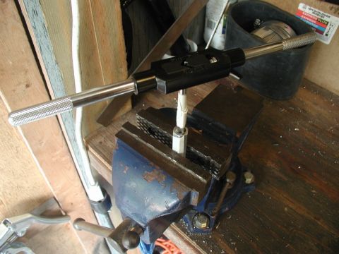 1990 Ford Thunderbird - Tool setup for threading a part held securely in a vise.