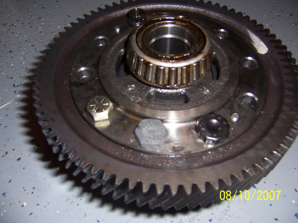 Differential ring gear assembly with tapered roller bearing on hub, resting on gray shop floor