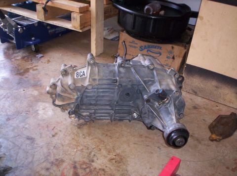 1995 Ford Bronco - A transfer case is shown, with a label reading "8CA" on its housing. The part appears to be used.