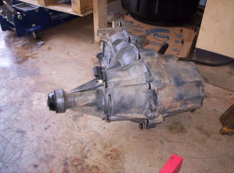 1995 Ford Bronco - Transfer case assembly shown on a concrete floor.