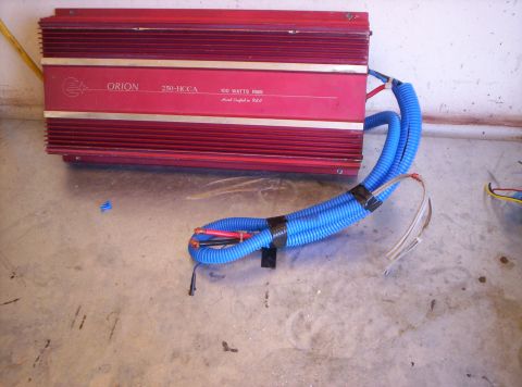 1995 Ford Bronco - A red Orion amplifier with 150 watts RMS is shown on a concrete floor.